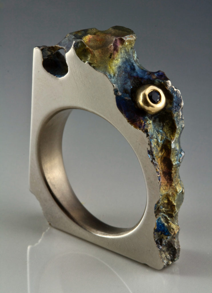 Ti Ring#11 Anodized Titanium, reclaim 12K gold & blue sapphire H1.2″W0.9″D0.3″ Ring size7.1/2